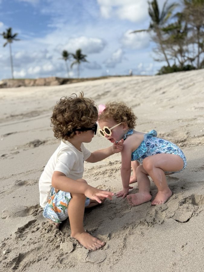Toddlers playing at the water's edge on a Punta Mita beach